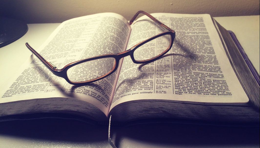 Picture of a bible with reading glasses on it