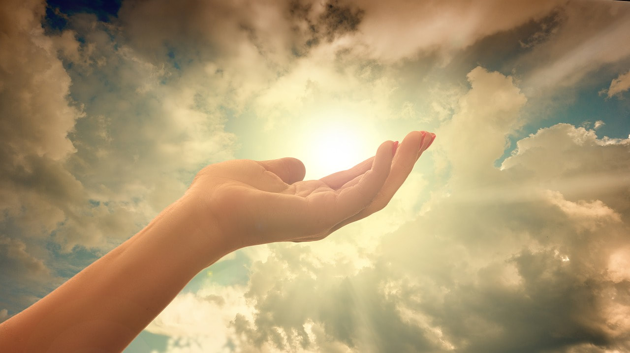 Stock image of a hand with the palm facing up to the sky